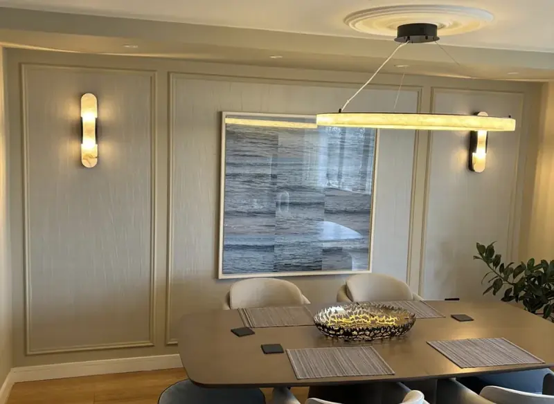 Dining room with brass sconces and panelled walls