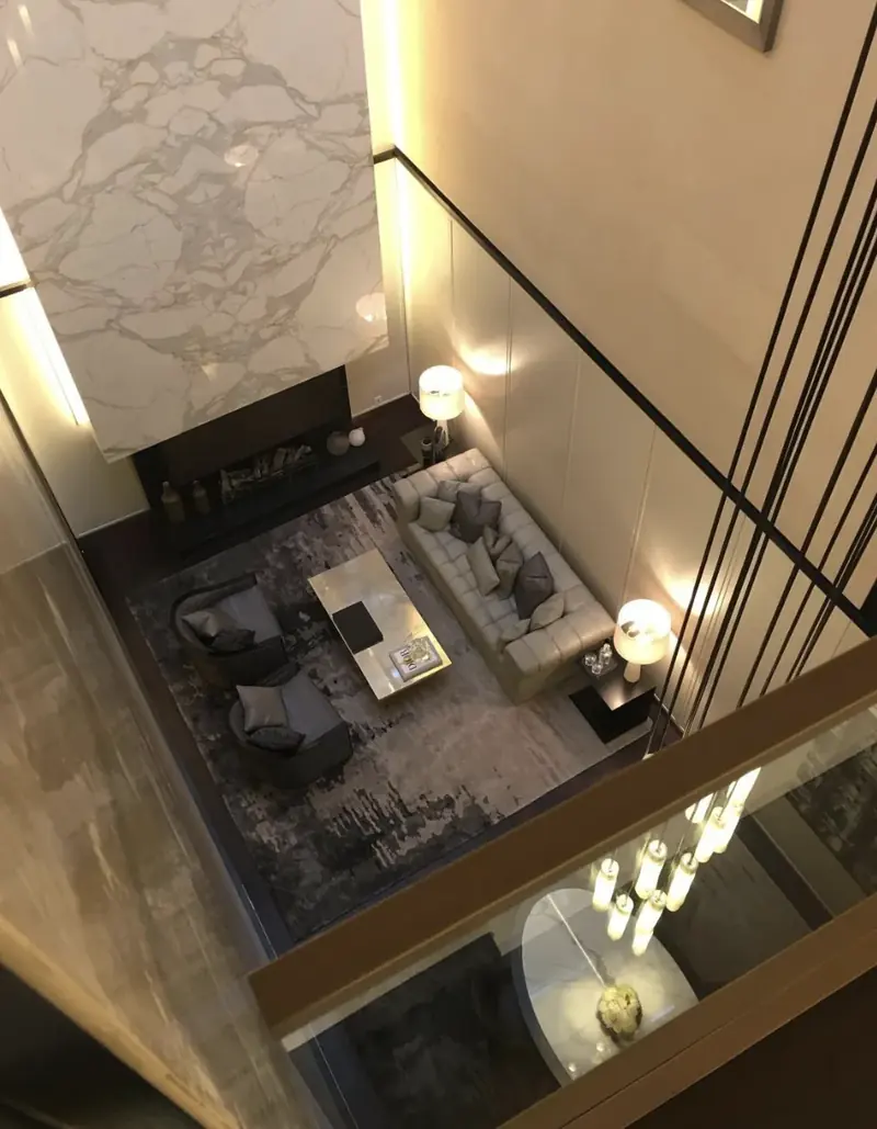 Double height living room with marble fireplace, seen from the landing